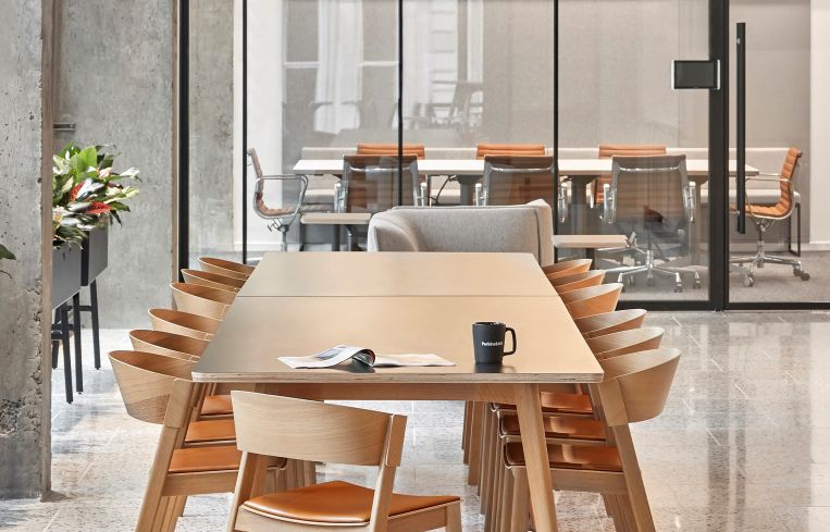 The pantry has a long table that includes outlets for working or hosting clients.