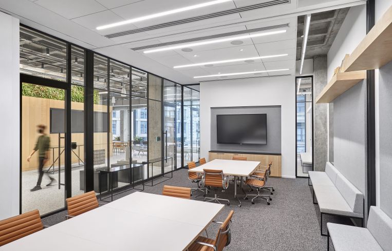 The large conference room has glassed-in walls and a retractable wall that can divide the room in half.