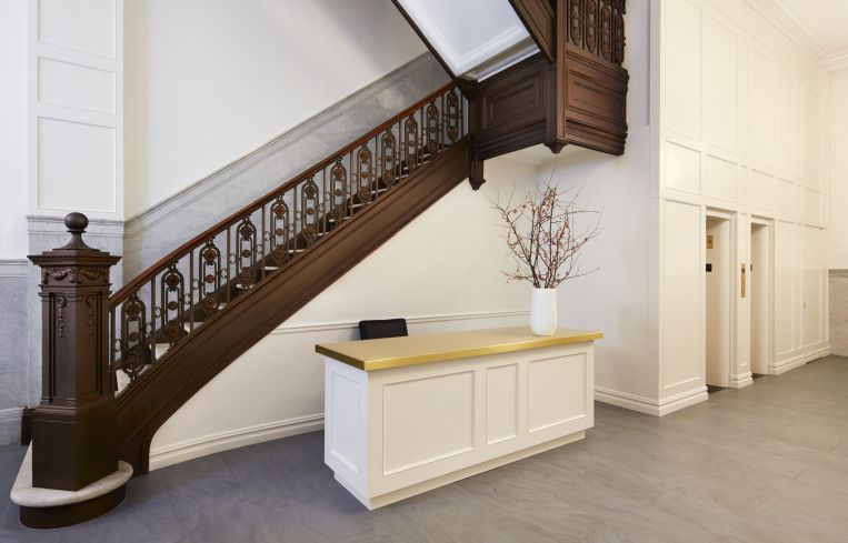 The marble and bronze staircase was sanded and restored to its original color.