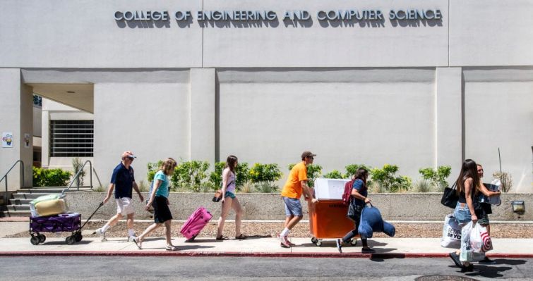 California State University Fullerton students along with the help of their parents and families move their belongings from their vehicles into the residence halls, in Fullerton.