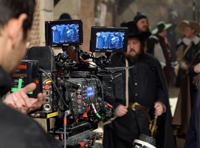 A camera films actor pose on set. After 2020, market experts said studio users would step further into the industrial market to convert into their own space in traditionally secondary markets.