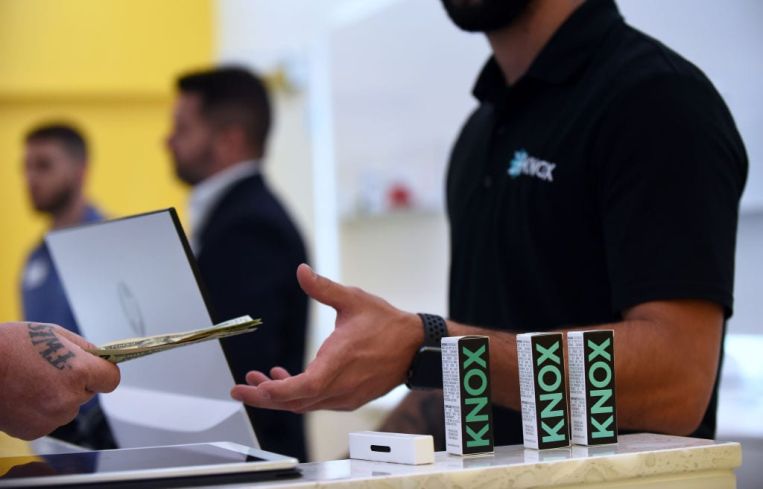 A patient pays for an order of medical marijuana at a new Knox medical marijuana dispensary in Florida.