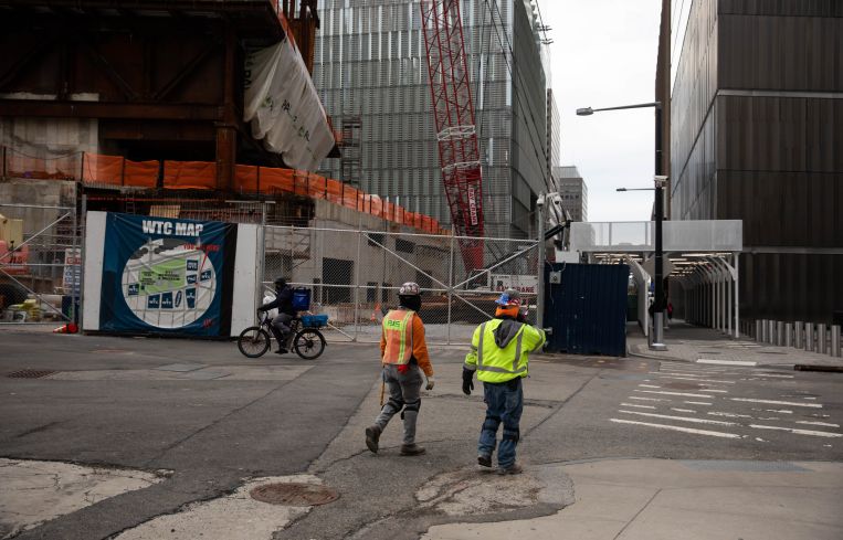 Construction workers in front of a construction site.