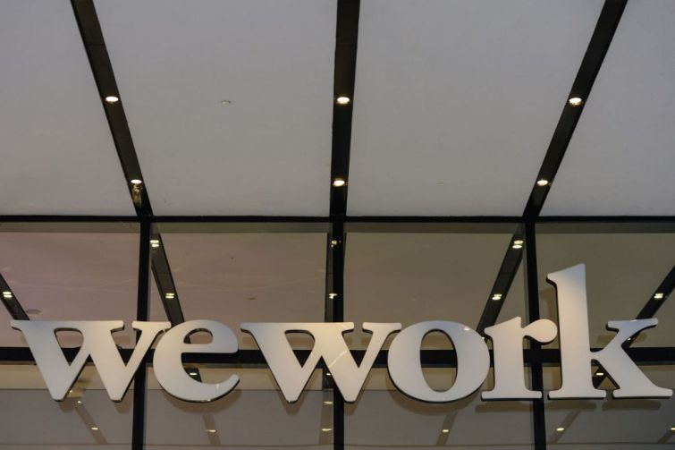 A closeup of a building entrance with the word "WeWork" over it.