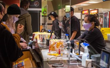 Moviegoers buy pop-corn and drinks at the AMC Burbank theatre concession stand on March 15.
