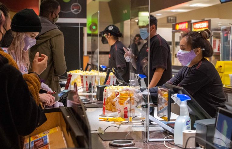 Moviegoers buy pop-corn and drinks at the AMC Burbank theatre concession stand on March 15.