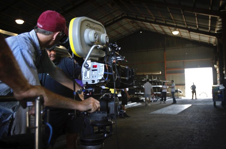 A shot is lined up while filming at a steel warehouse in Lancaster for a CBS show.