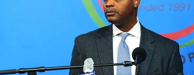 A man at a bank of microphones.