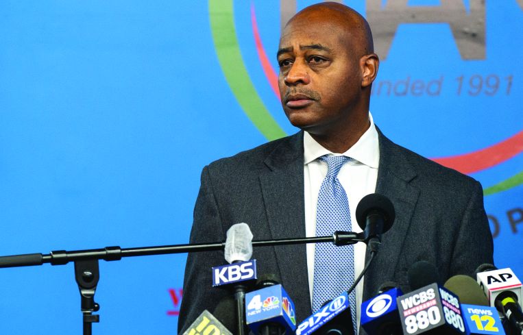 A man at a bank of microphones.
