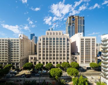 The historic Trust Building is a large grey art deco building located in downtown Los Angeles.