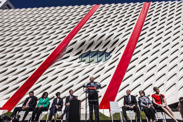 A civic dedication and ribbon-cutting ceremony in 2015 for The Broad museum in Downtown Los Angeles. Eli Broad center, is flanked by former California Gov. Jerry Brown to the right, and Mayor Eric Garcetti to the left. The $140 million museum houses the Broads' art collections. The building was designed by Diller Scofidio + Renfro.