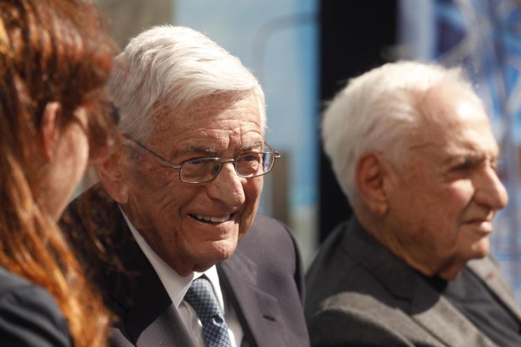 Eli Broad, left, enjoys a light moment with architect Frank Gehry, right, during an interview at the ground-breaking ceremony for the $1 billion Grand Avenue Project called The Grand (designed by Gehry) in Downtown Los Angeles in February 2019. The complex of condominiums, apartments, shops, restaurants and a hotel has been delayed several times since 2004, when Related Companies was selected by city and county officials to transform the property.