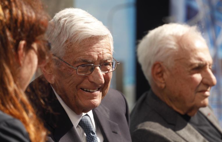 Eli Broad, left, enjoys a light moment with architect Frank Gehry, right, during an interview at the ground-breaking ceremony for the $1 billion Grand Avenue Project called The Grand (designed by Gehry) in Downtown Los Angeles in February 2019. The complex of condominiums, apartments, shops, restaurants and a hotel has been delayed several times since 2004, when Related Companies was selected by city and county officials to transform the property.