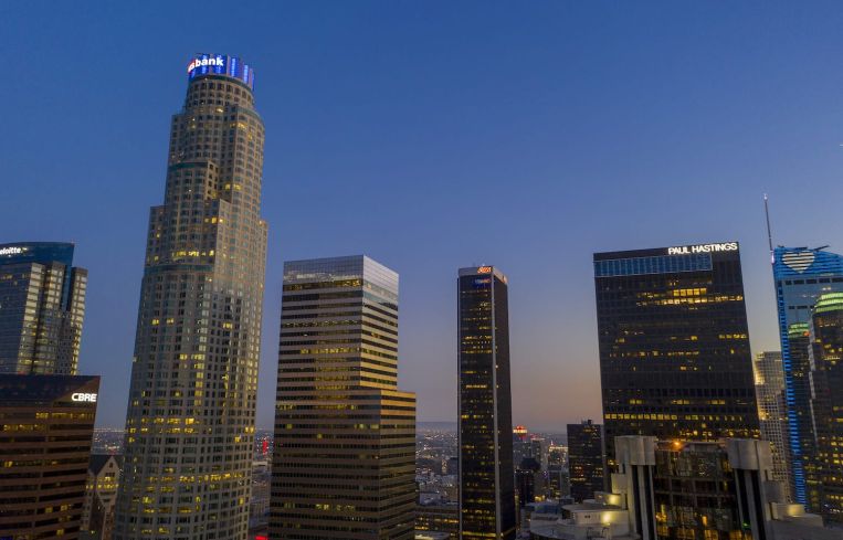 Maguire’s trophy developments include the 73-story U.S. Bank Tower, left, one of the tallest buildings west of the Mississippi River.