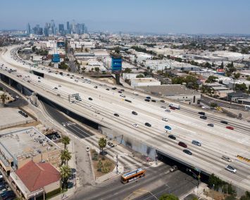 Tall buildings in the distance over highways.