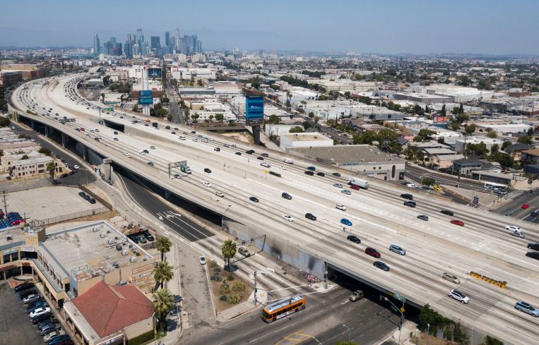 Tall buildings in the distance over highways.