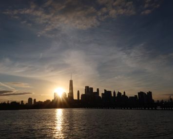 Dawn breaking over tall buildings.