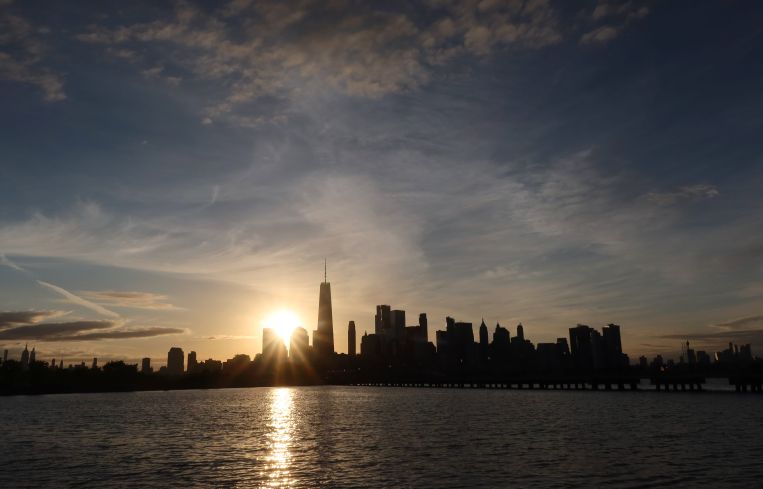 Dawn breaking over tall buildings.