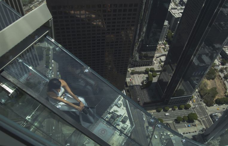 A woman slides down the Skyslide, 70 floors up on the outside of the U.S. Bank Tower in June, 2016