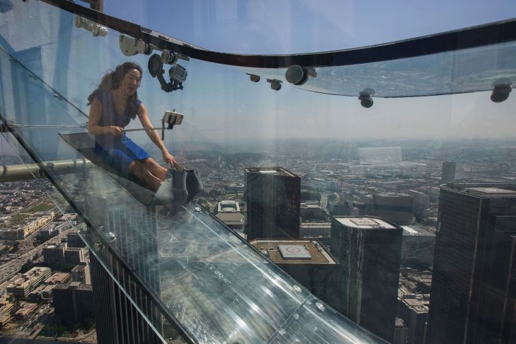 A woman slides down the Skyslide, 70 floors up on the outside of the U.S. Bank Tower in June, 2016