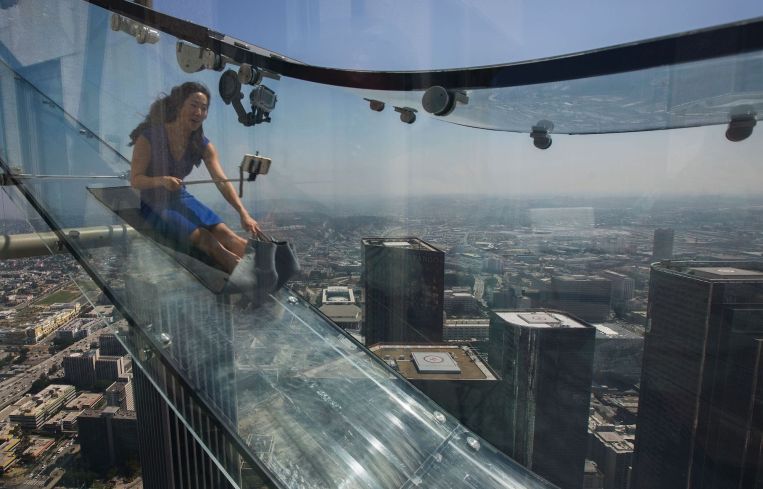A woman slides down the Skyslide, 70 floors up on the outside of the U.S. Bank Tower in June, 2016