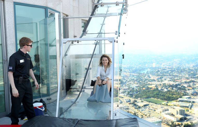 A woman slides down the Skyslide, 70 floors up on the outside of the U.S. Bank Tower in June, 2016