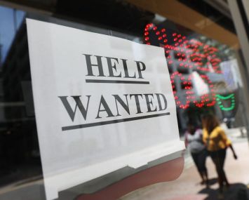 A "help wanted" sign hangs on a window of a restaurant in Miami, Florida.