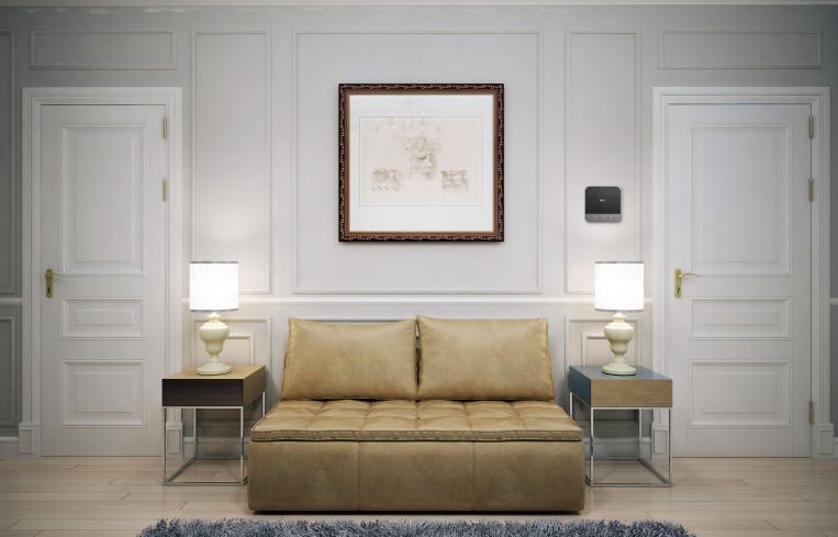 An apartment with a yellow, centered couch and two lamps on either side.