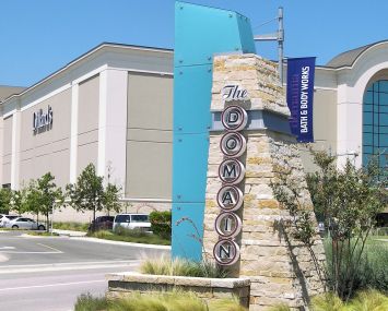 An image of one section of Simon Property Group's The Domain, with Dillard's in the background.