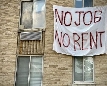 A banner against renters eviction reading no job, no rent is displayed on a controlled rent building in Washington, DC.