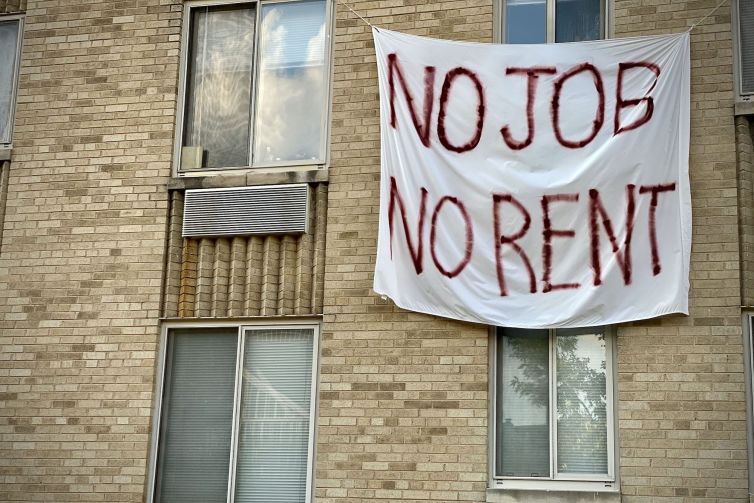 A banner against renters eviction reading no job, no rent is displayed on a controlled rent building in Washington, DC.