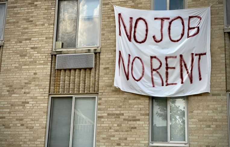 A banner against renters eviction reading no job, no rent is displayed on a controlled rent building in Washington, DC.