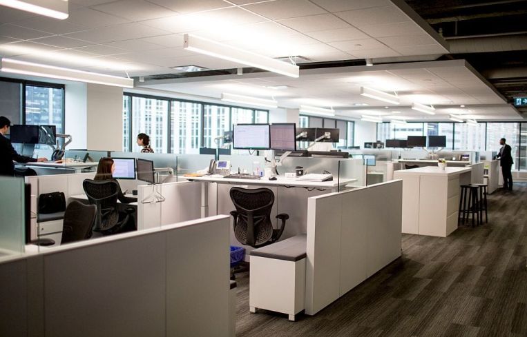 Sit/stand workstations in an office.
