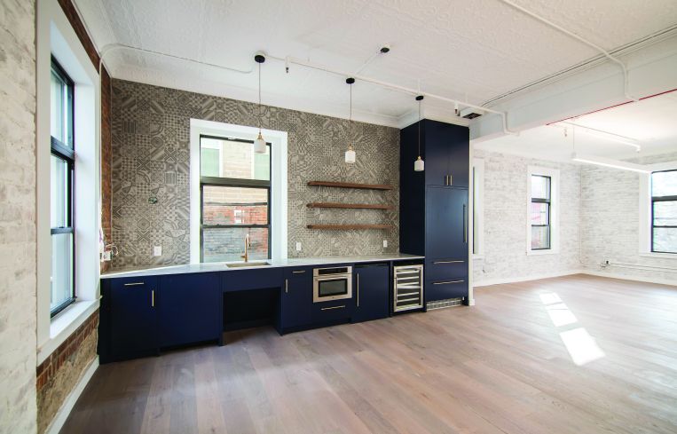 Upstairs there are newly installed tin ceilings (painted white in an effort to make them feel vintage), oak floors, and high-end kitchens and bathrooms for office tenants.