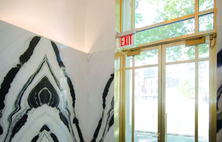 The remainder of the lobby is clad in black and white panda marble and brass.