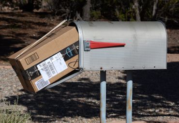 An Amazon Prime package delivered to a mailbox.
