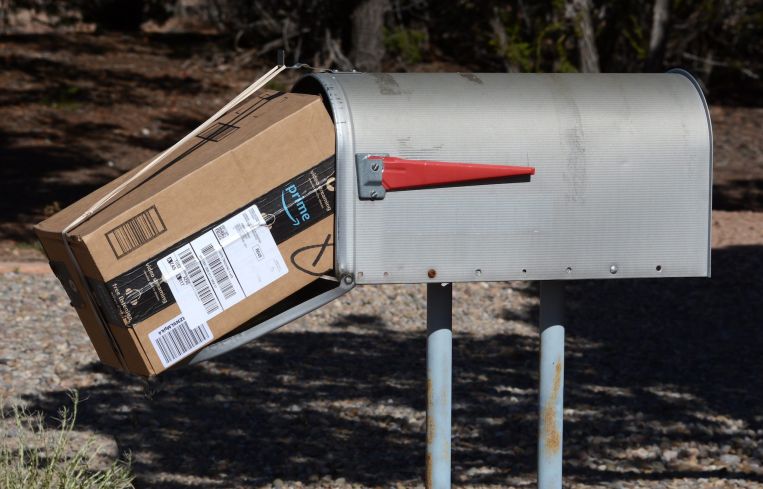 An Amazon Prime package delivered to a mailbox.