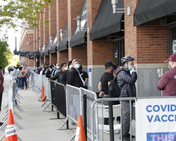 People waiting in line to get into a building.