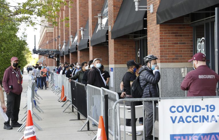 People waiting in line to get into a building.