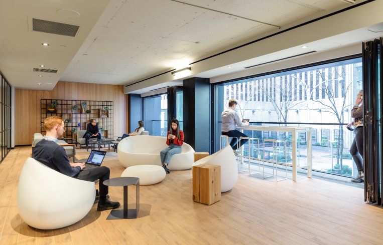 One seating area faces a terrace with retractable glass doors.