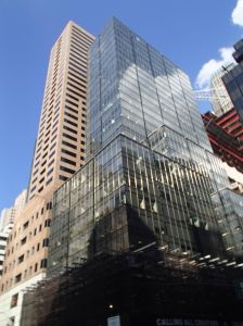 A tall, glass covered grey skyscraper at 565 Fifth Avenue.