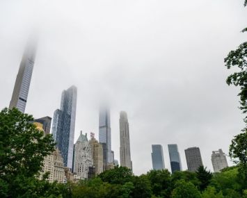 Fog hangs over skyscrapers in Central Park.