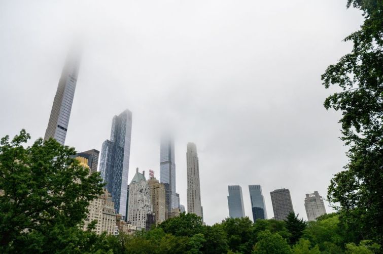 Fog hangs over skyscrapers in Central Park.