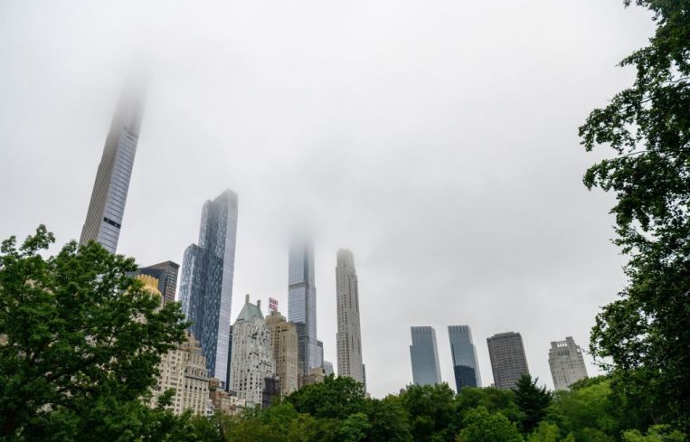 Fog hangs over skyscrapers in Central Park.