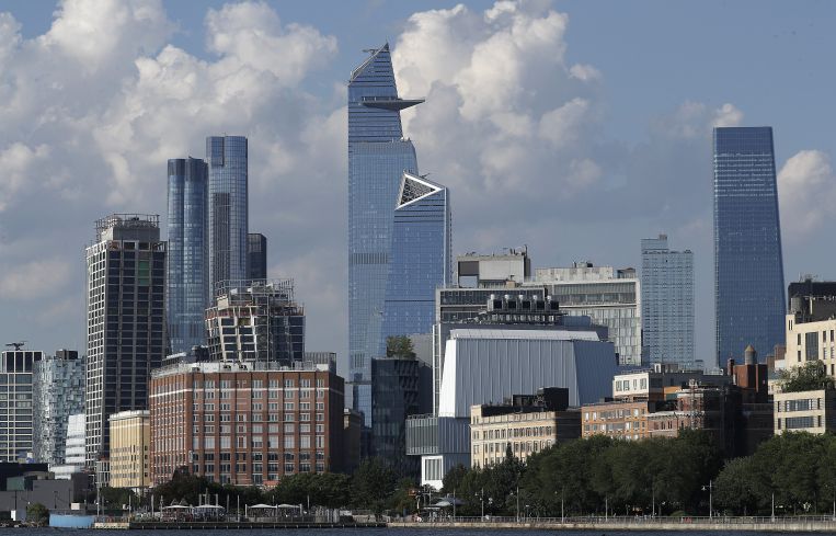 Some tall, glassy buildings along a waterfront.
