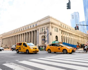 A squat, square building amid traffic.