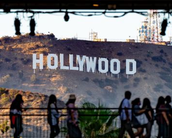 Shoppers passing by the Hollywood Sign at the Hollywood & Highland shopping center on July 19.