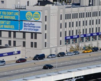 A big billboard next to a highway.