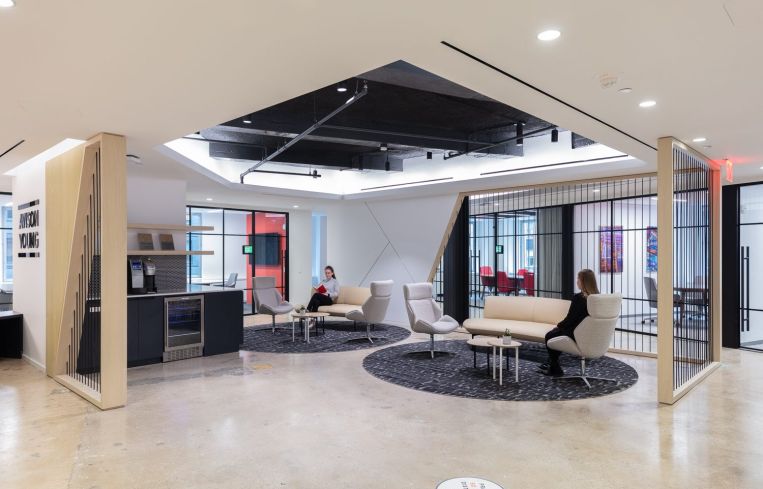 The space has various seating areas, including one behind the reception desk.