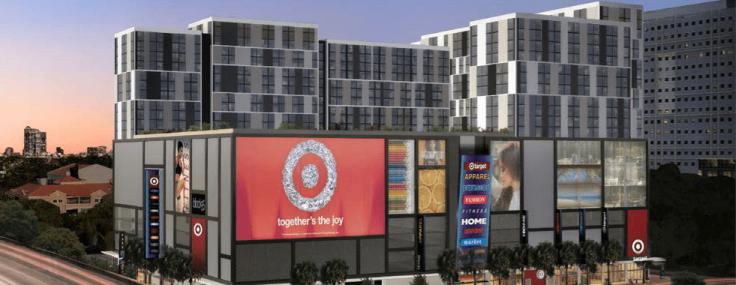 A large apartment complex with a target in front with a large red target sign.